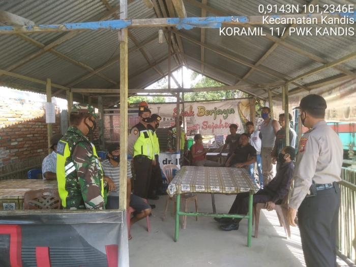 Cegah Penyebaran Covid 19, Anggota Koramil 11 Kandis Gencar Lakukan Patroli Prokes
